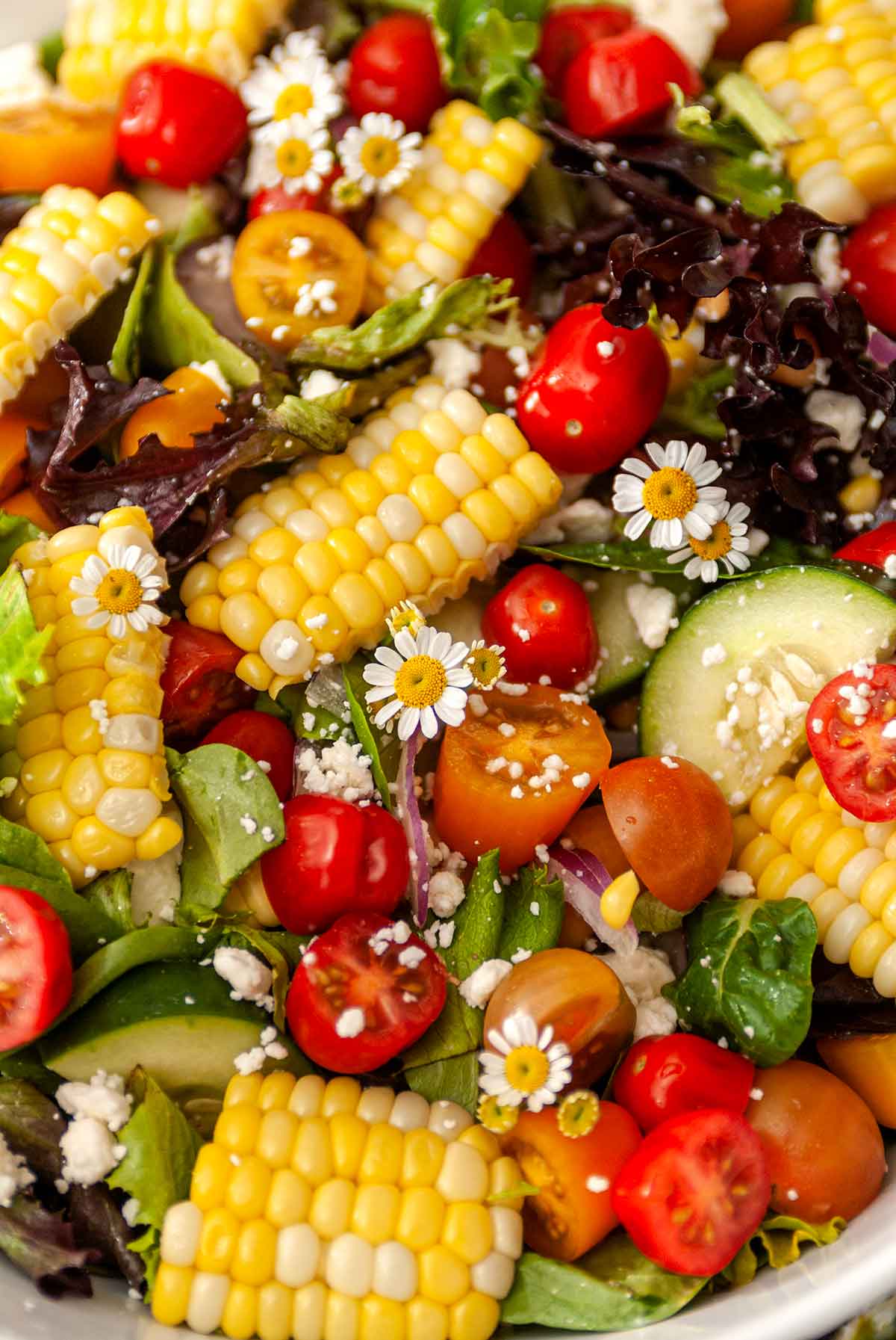 The corn and flowers in a summer salad.
