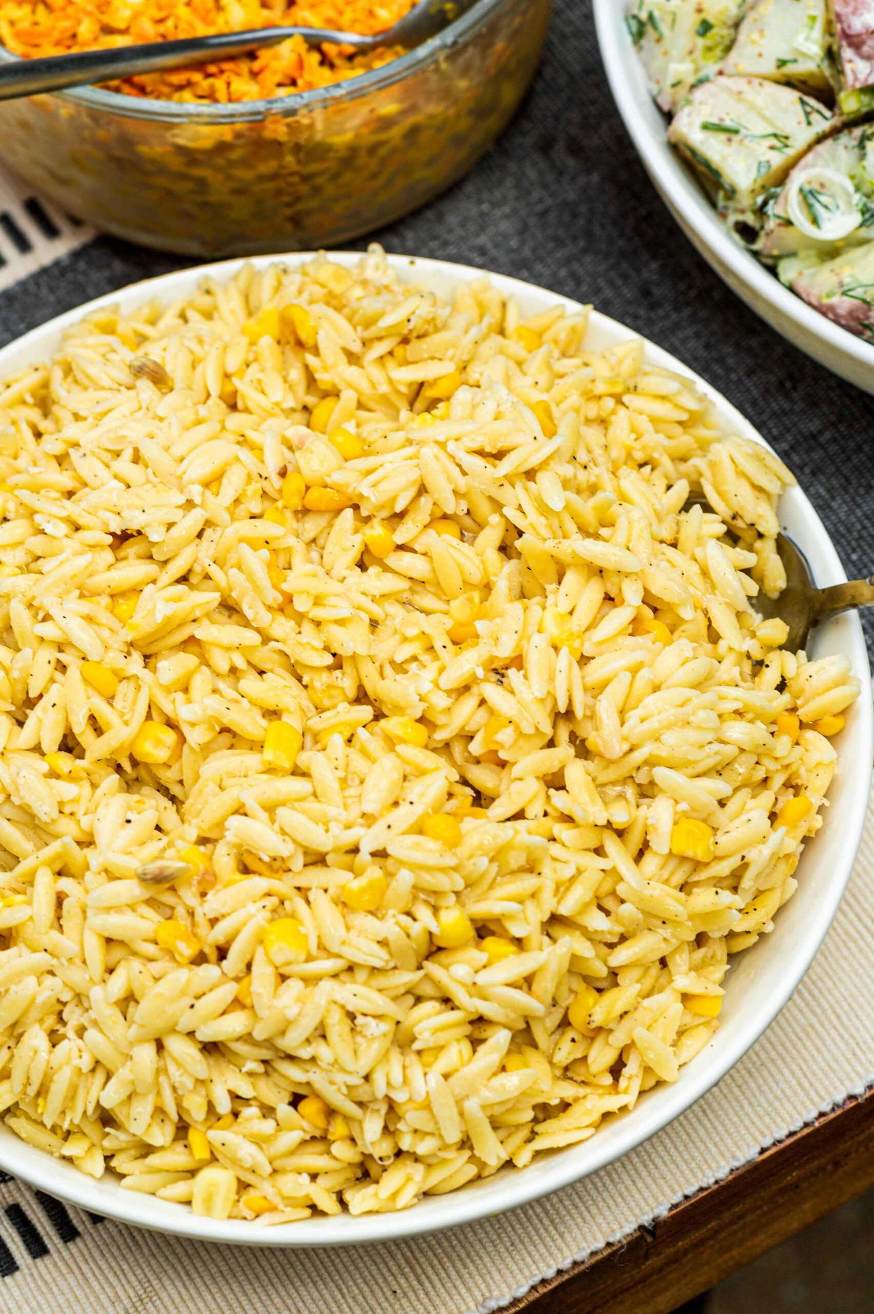 A bowl of lemon orzo on a table.