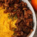 Pumpkin polenta with mushrooms in a bowl.