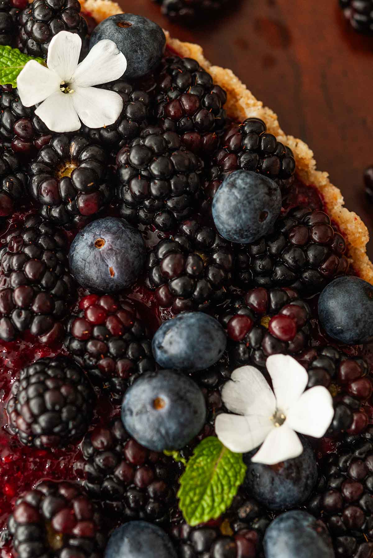 The flowers and berries on a cheesecake.