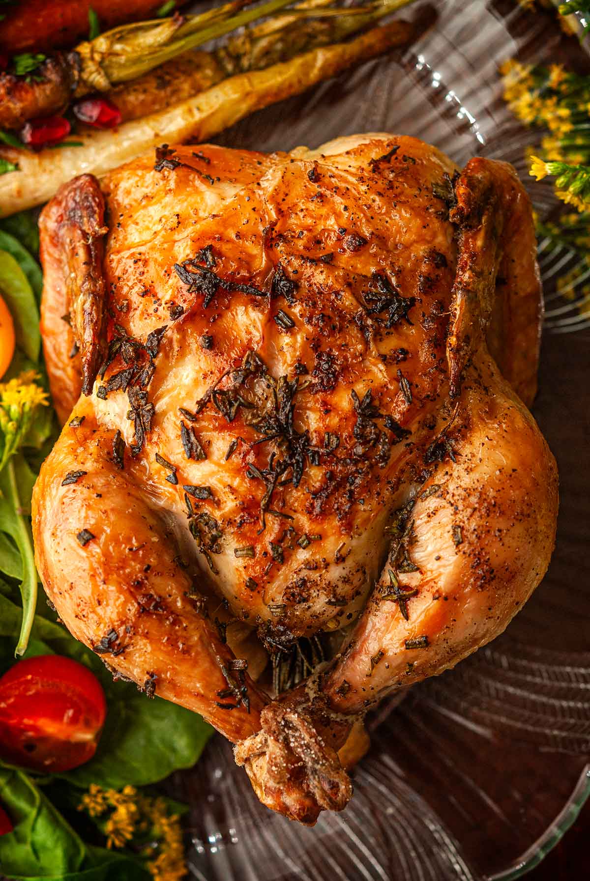 An herbed Cornish game hen on a plate.