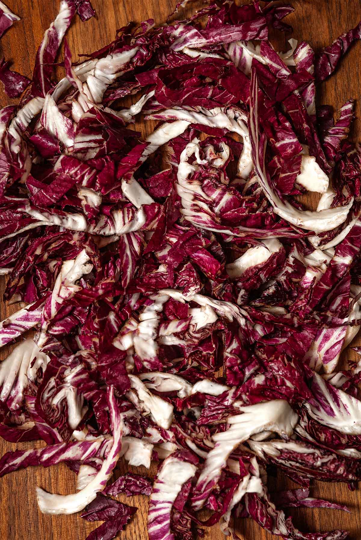 Thinly sliced radicchio on a cutting board.