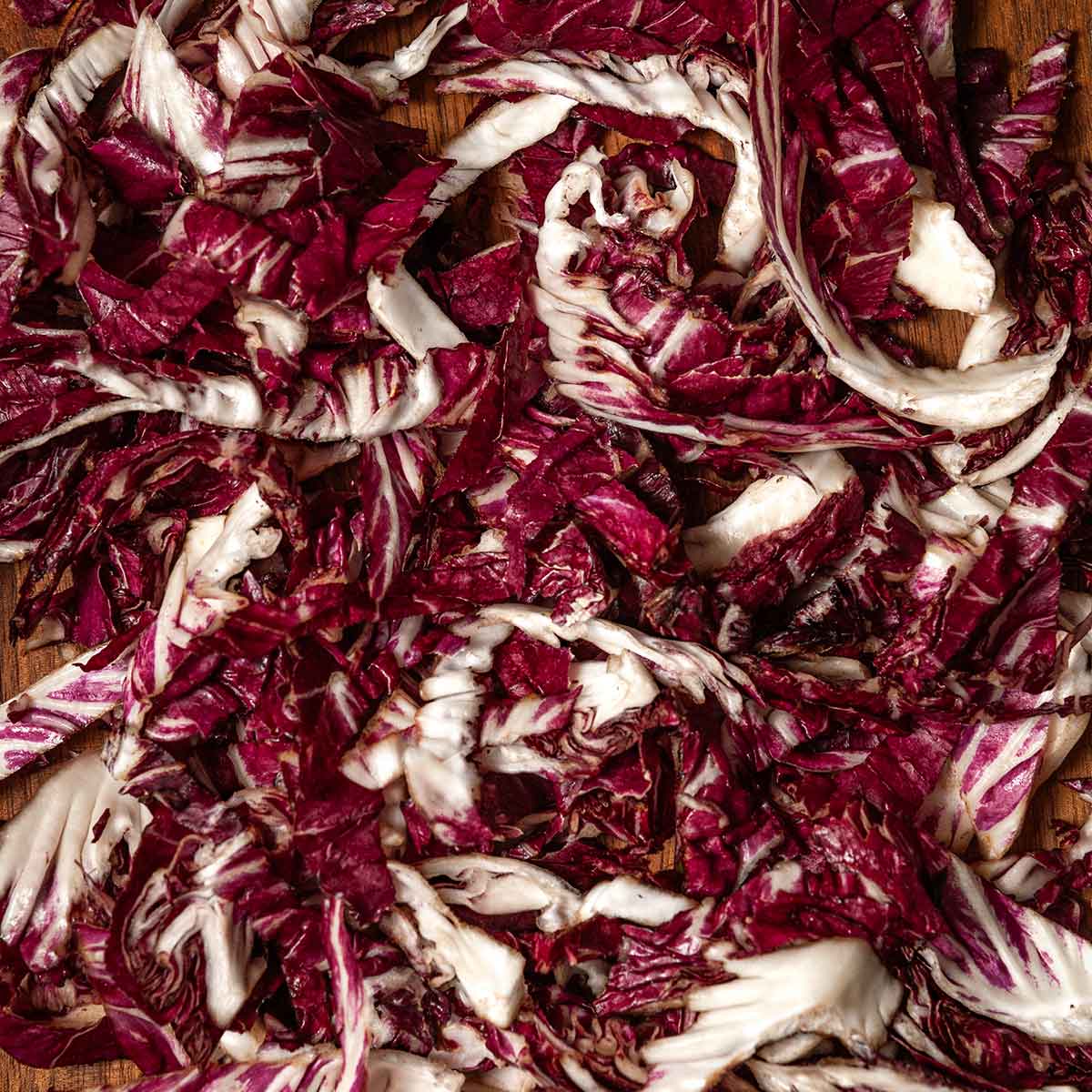 Thinly sliced radicchio on a cutting board.