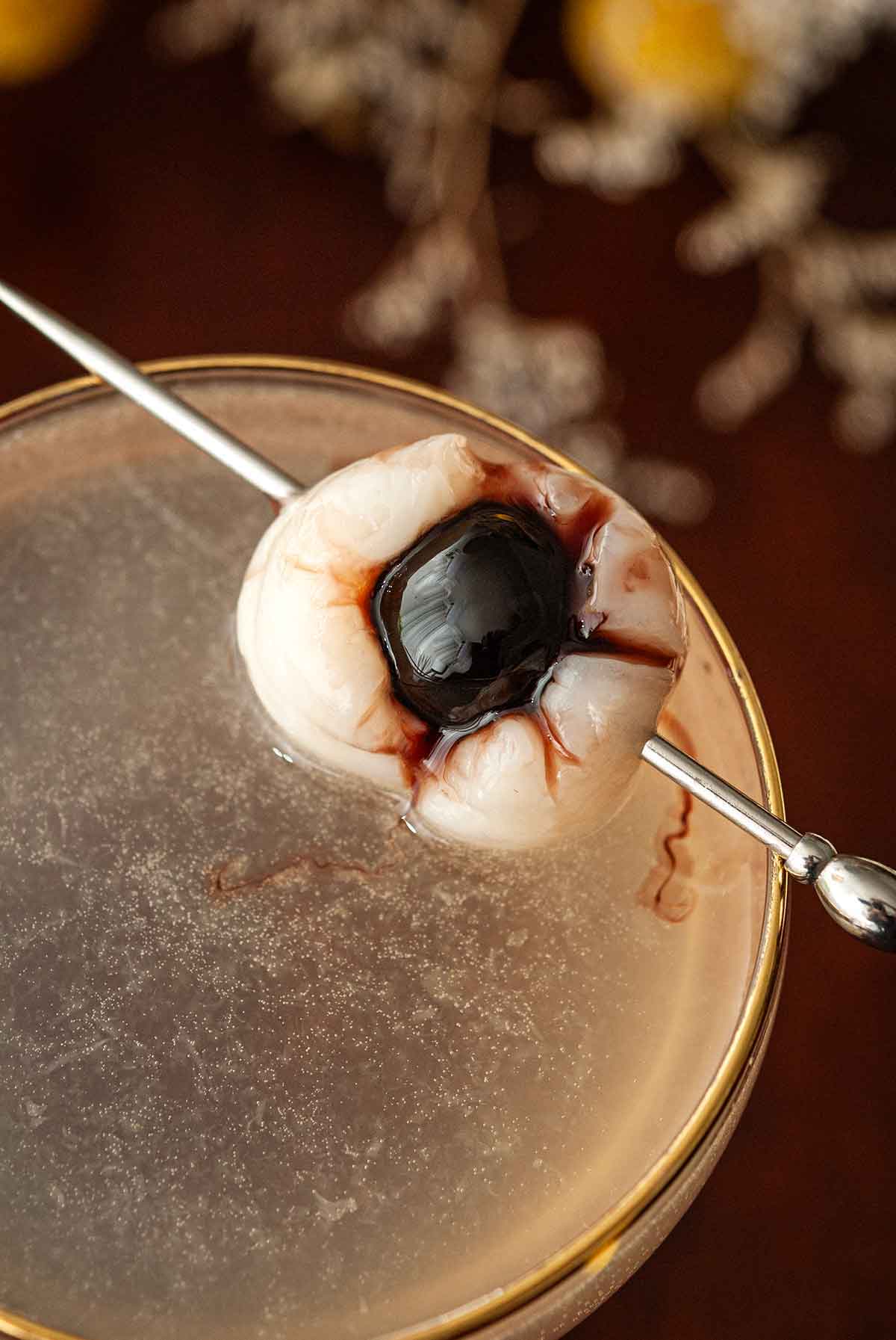 A lychee "eyeball" garnish on a cocktail.