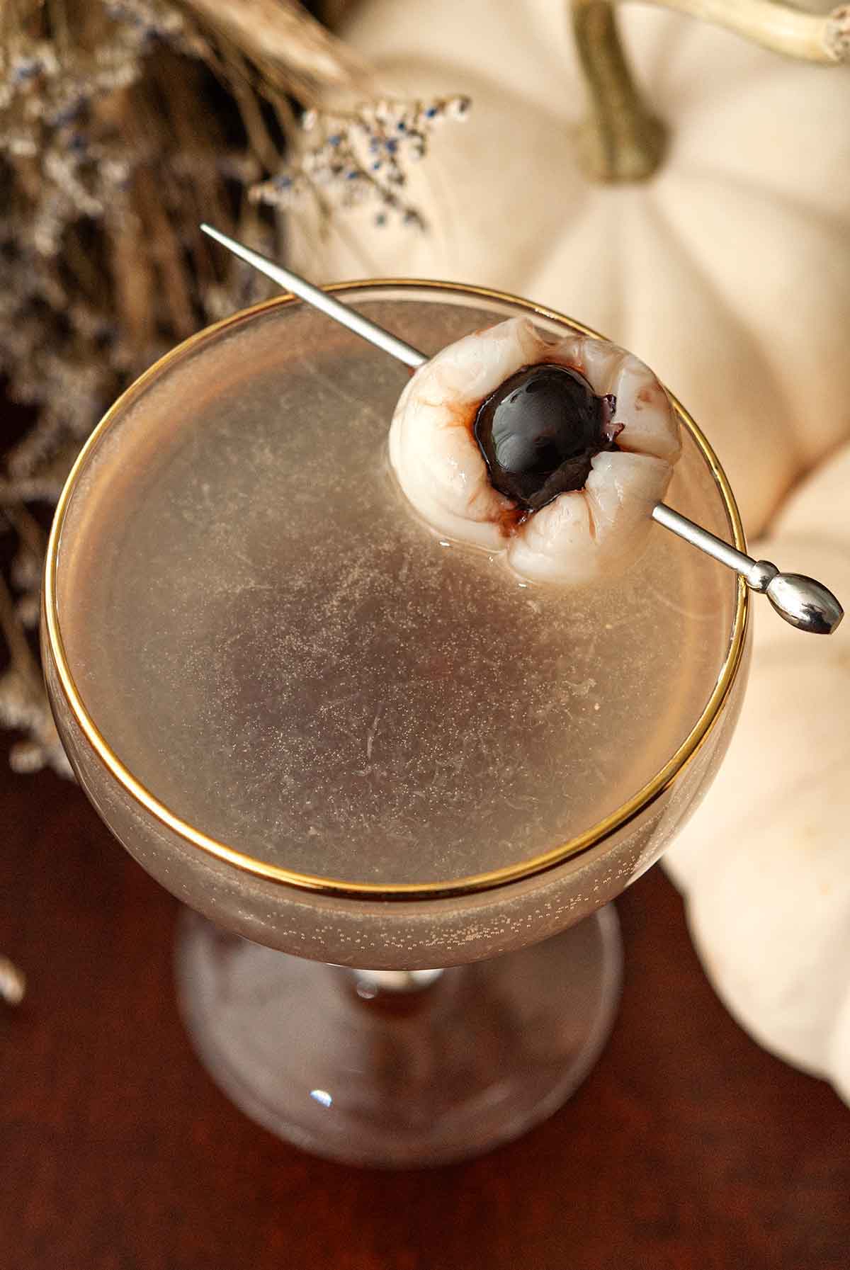 A lychee "eyeball" garnish on a cocktail.