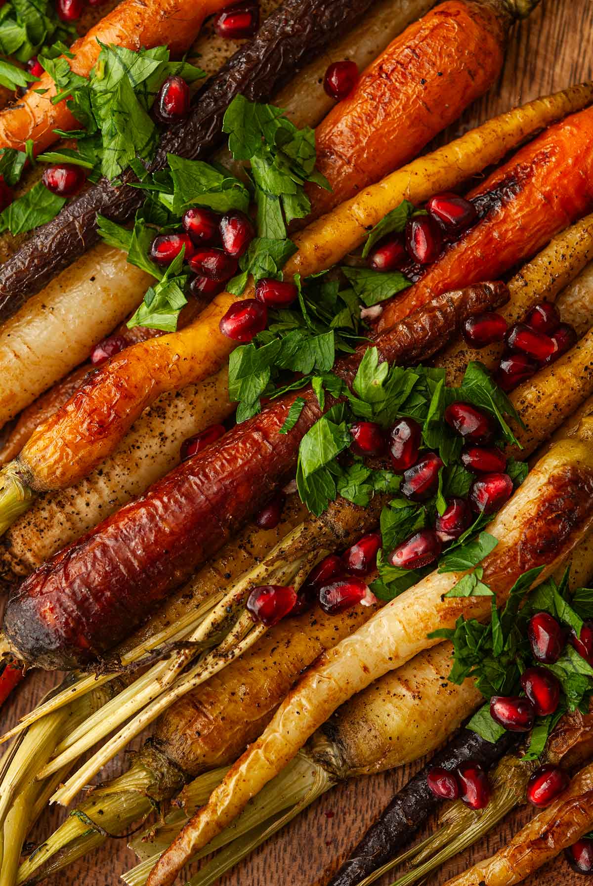 The parsley and pomegranate garnish on roasted rainbow carrots.