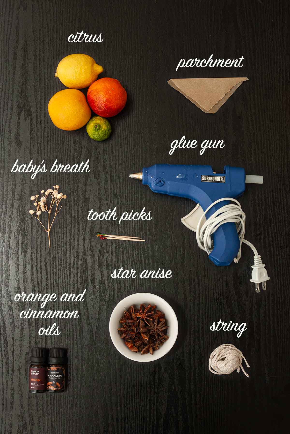 8 objects on a table needed to make citrus ornaments.
