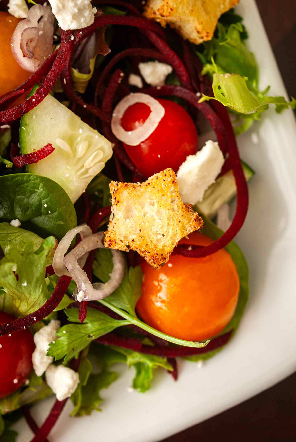 A star crouton in the corner of a salad.