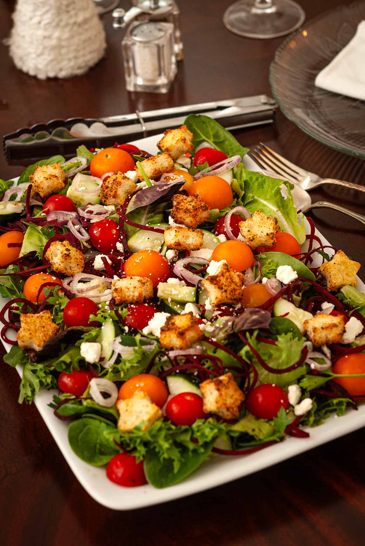 A festive salad with star-shaped croutons on a set dining table.