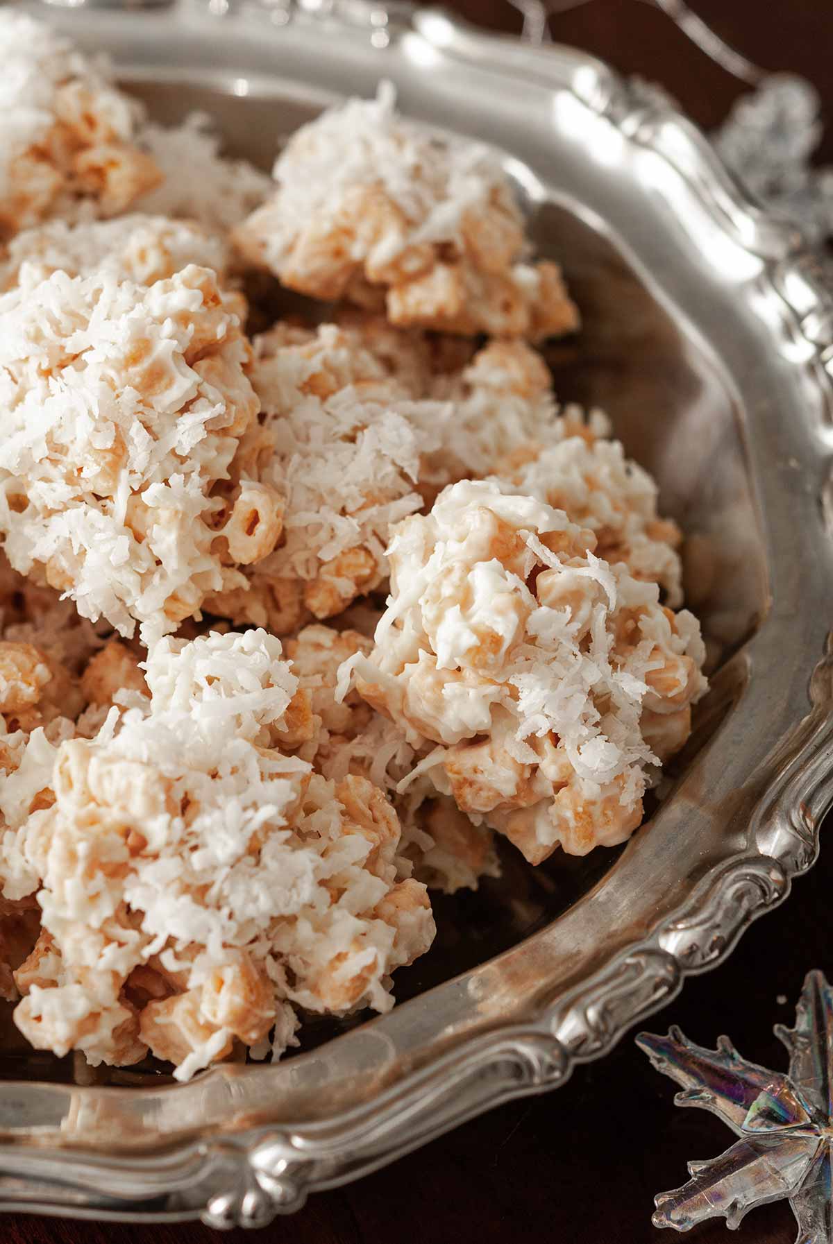 Coconut cookies in a decorative silver bowl.