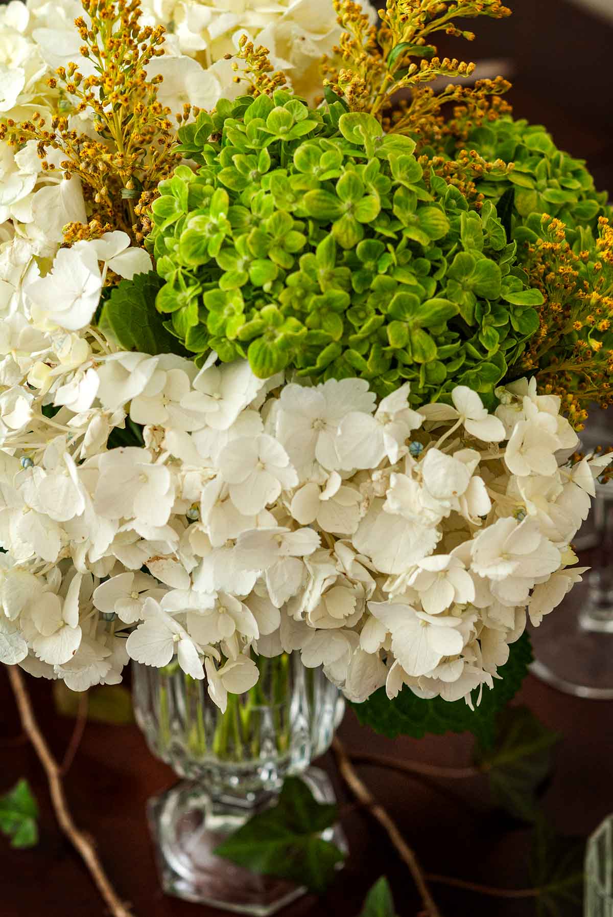 A bouquet of different color hydrangeas and goldenrod.