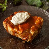 A slice of bread pudding on a plate.