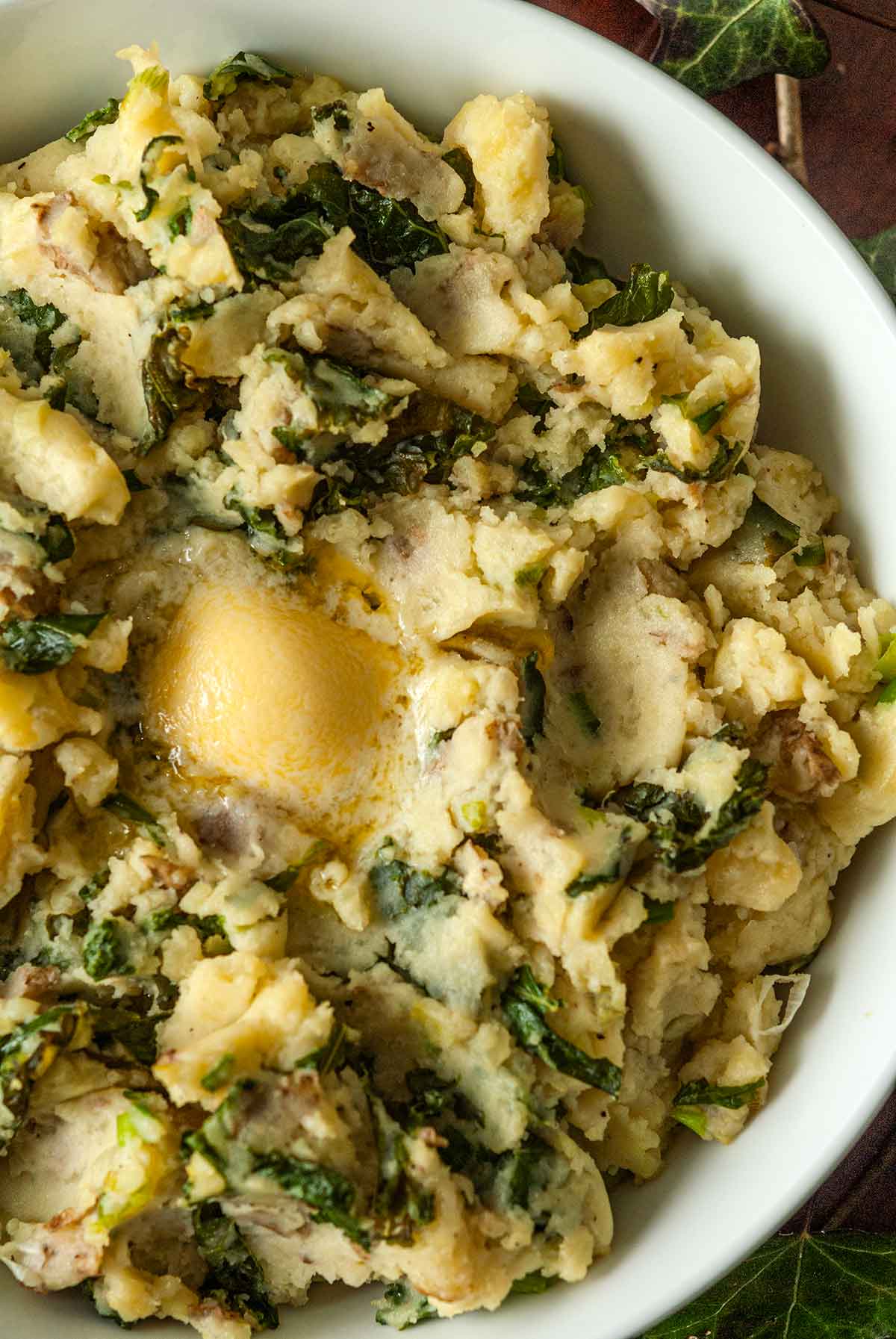 A bowl of colcannon with butter in the center.