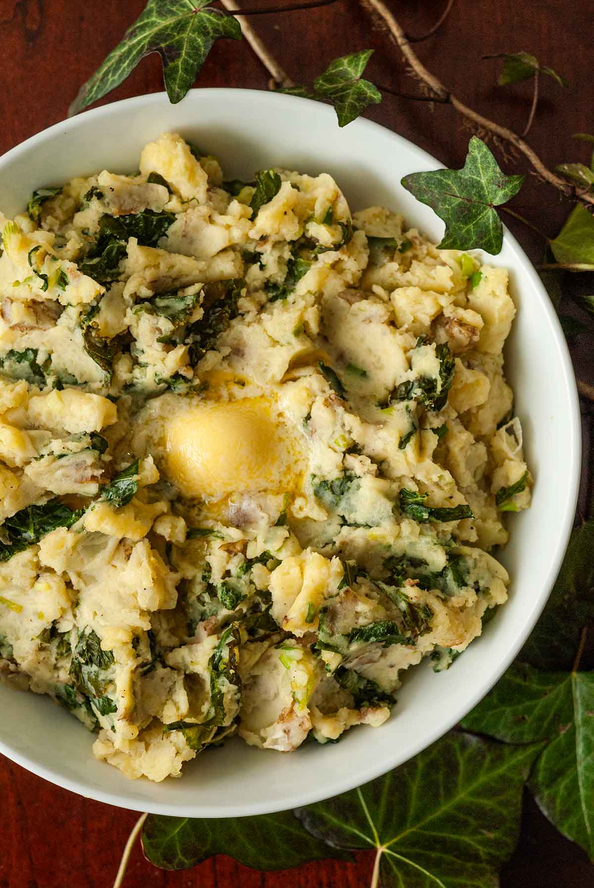 The top of a bowl of colcannon with butter in the center.