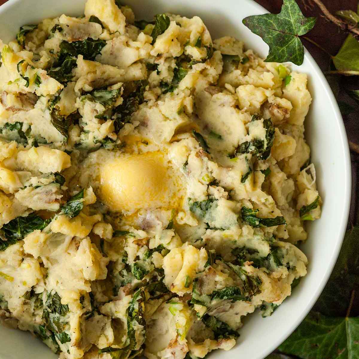 A bowl of colcannon with butter in the center.