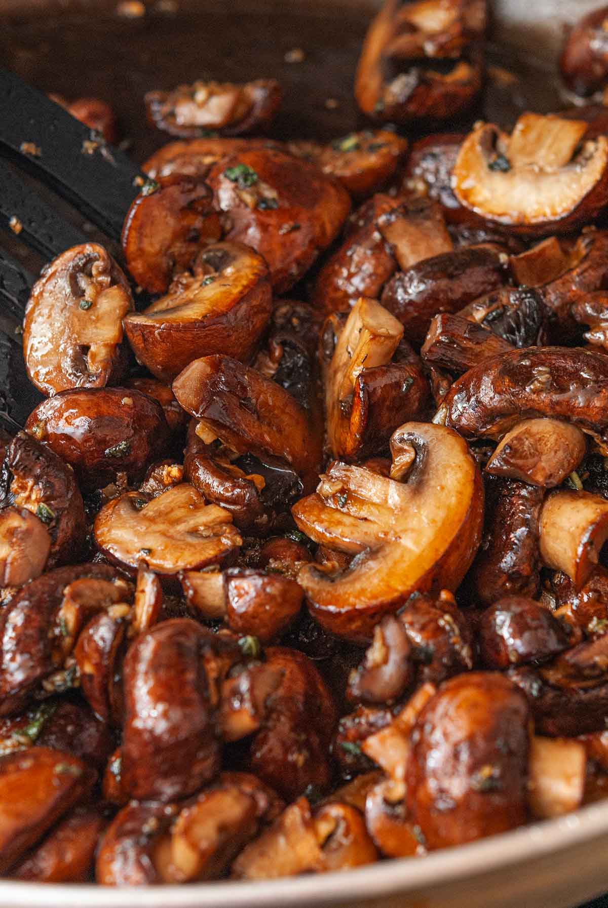 Seared, buttery mushrooms in a pan.
