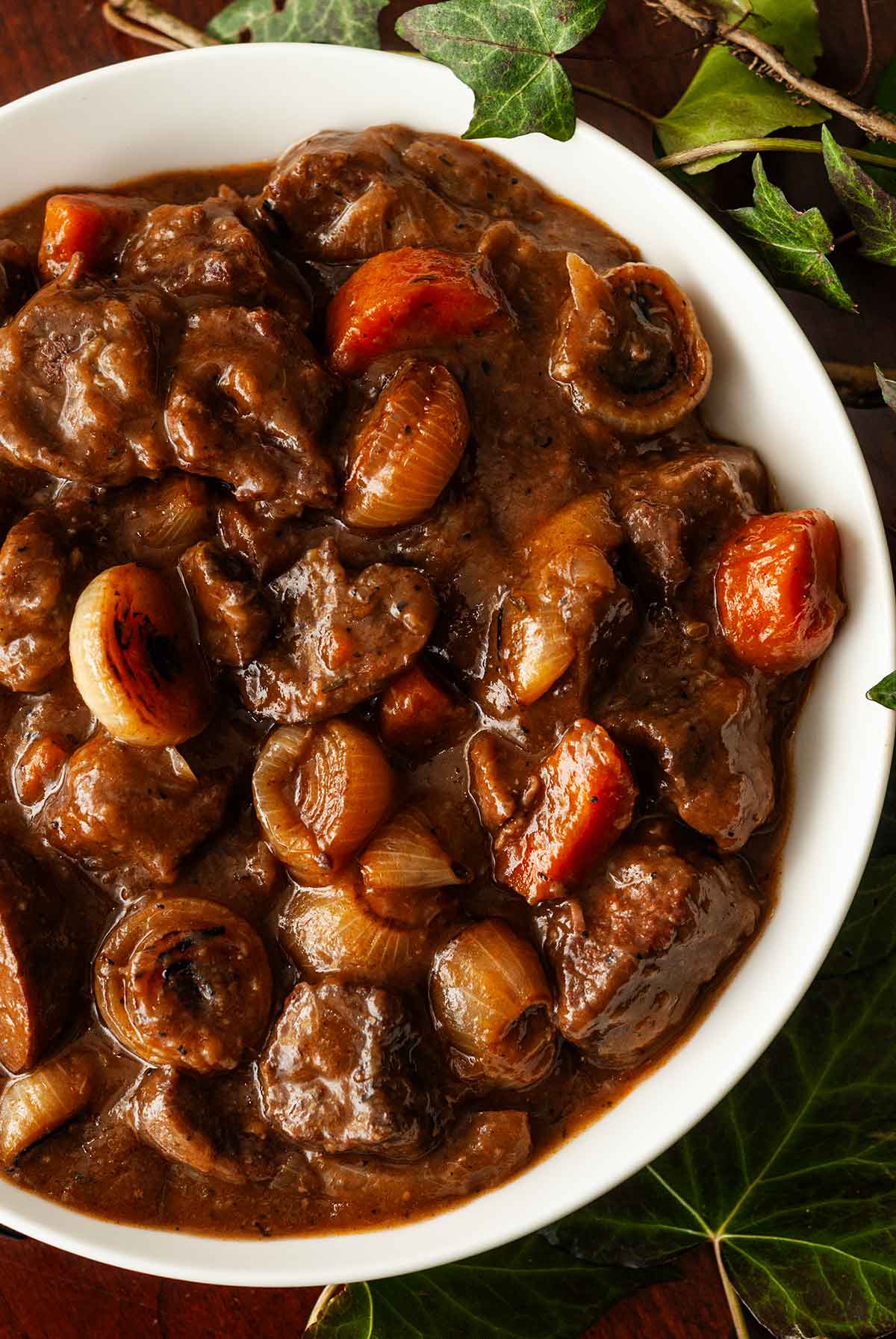 A bowl of lamb stew surrounded by ivy.