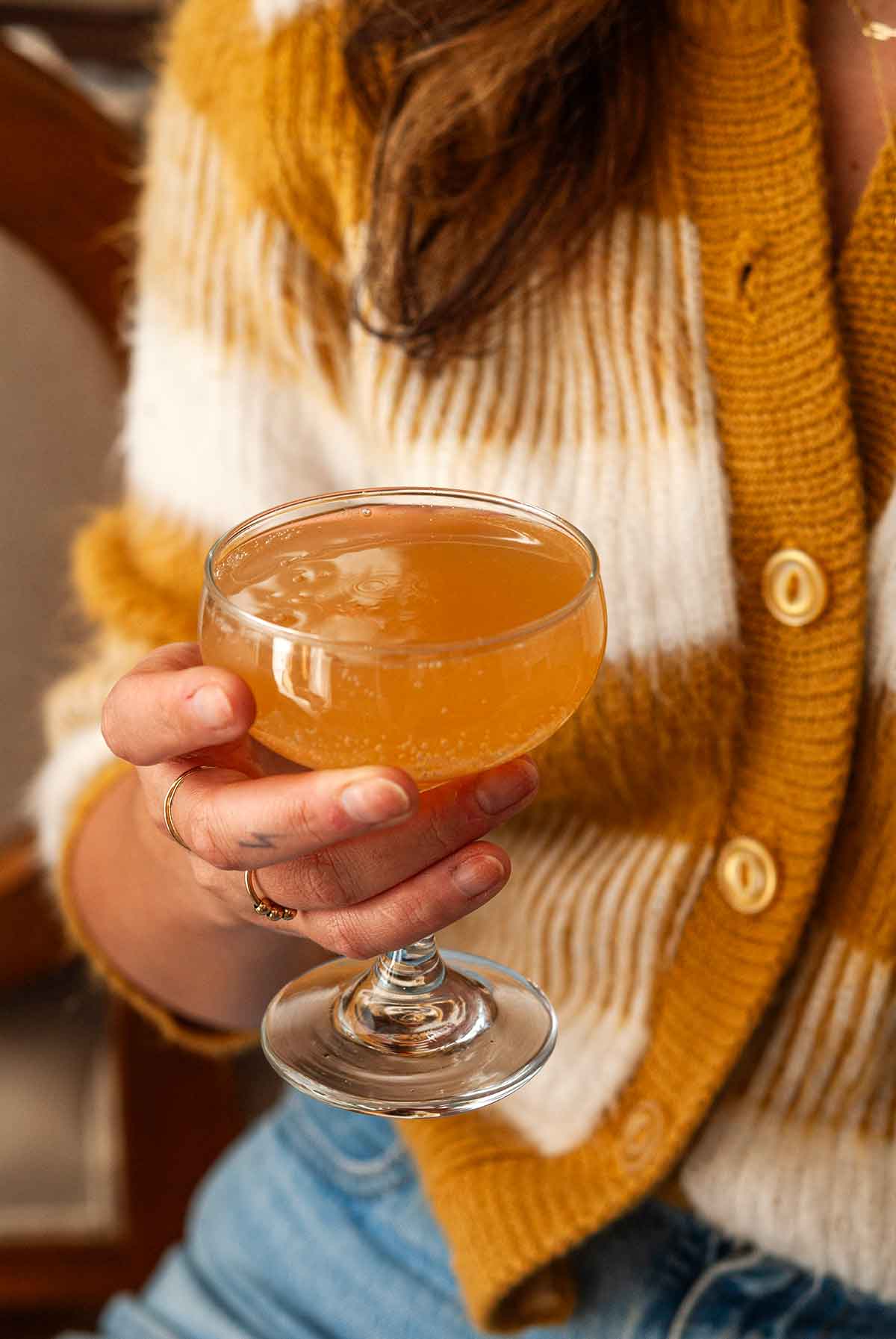 A woman's hand holding a cocktail.