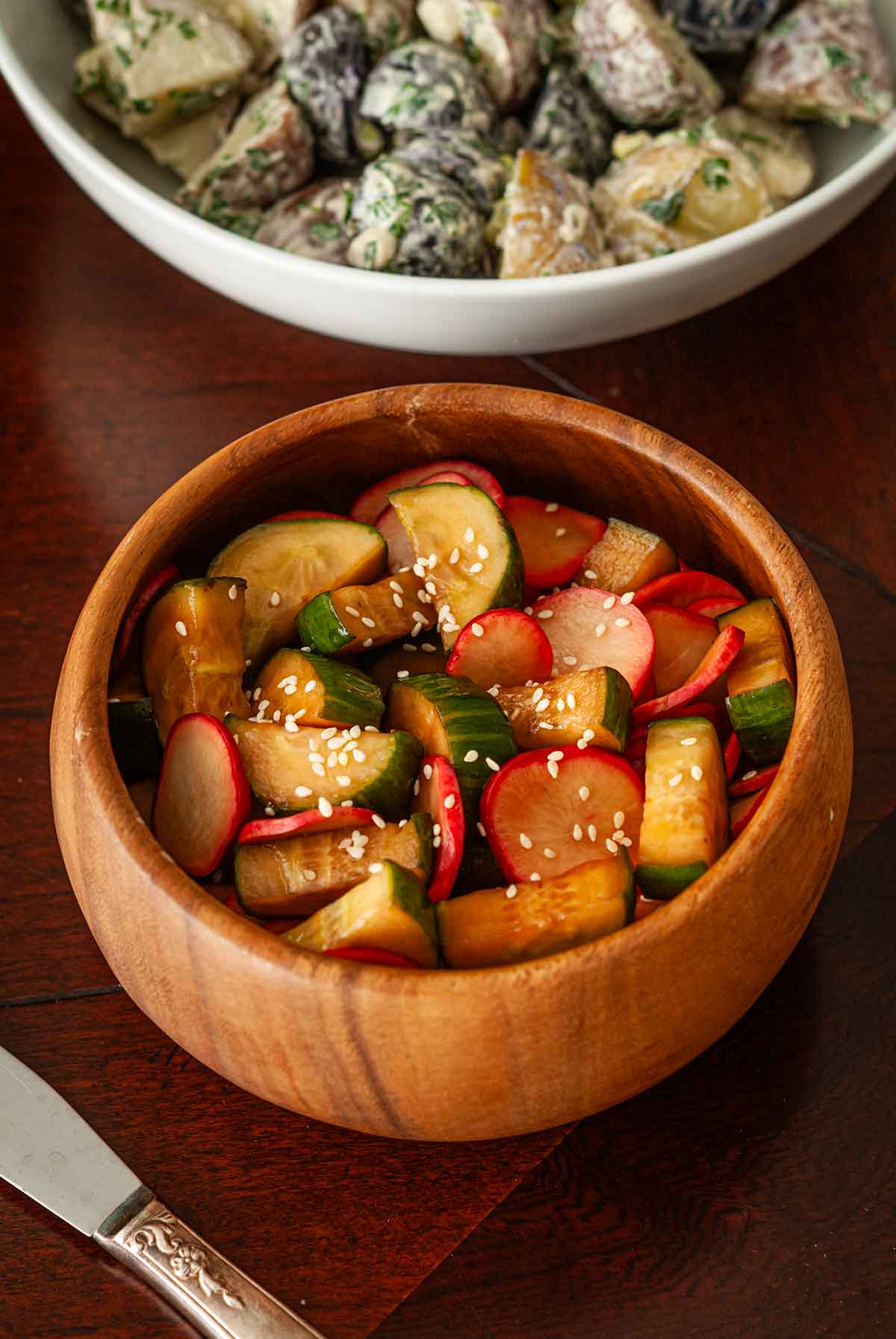 A bowl of ponzu cucumbers and radishes.