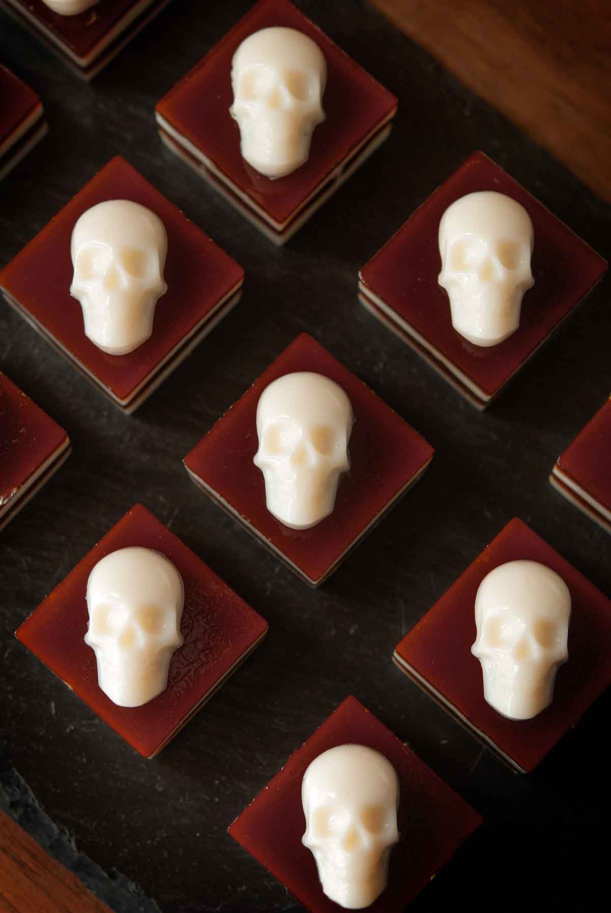 8 skull jello shots on a plate.