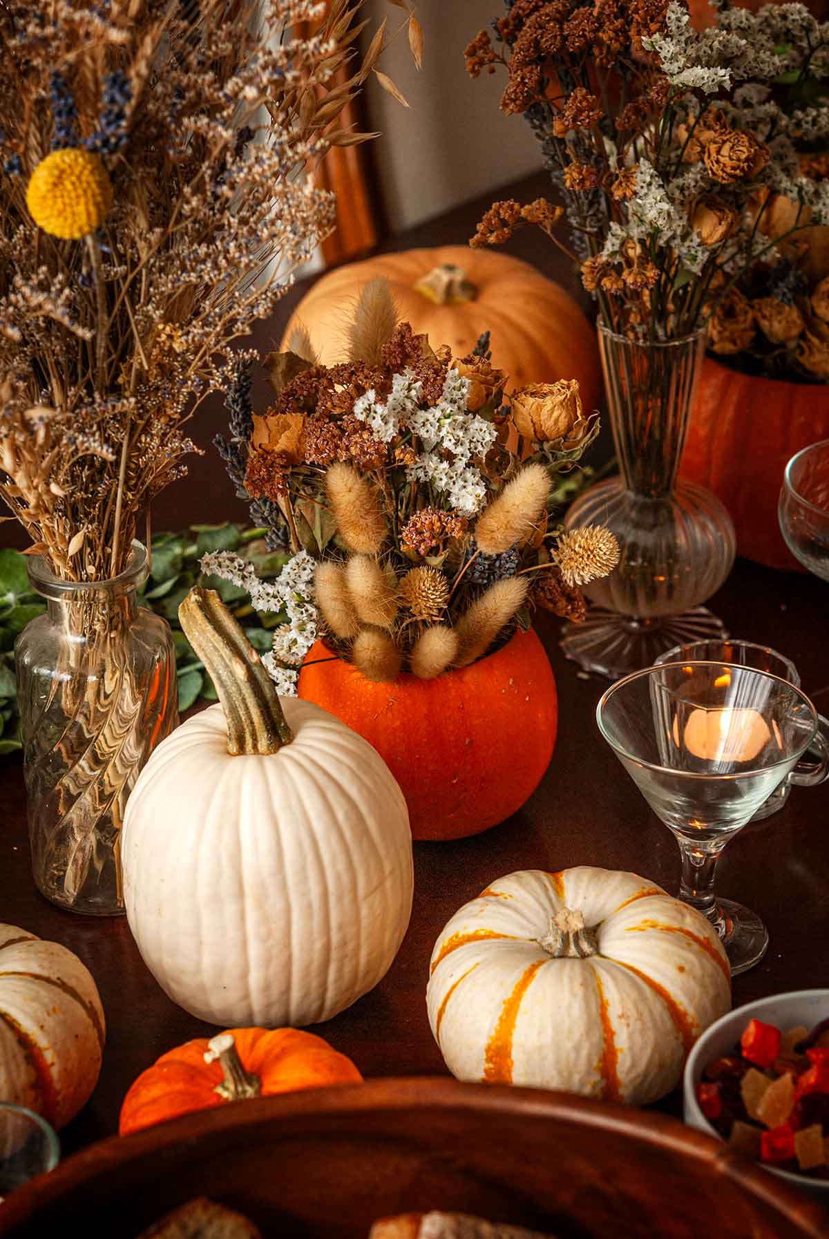 Assorted pumpkins and bouquets on a table.