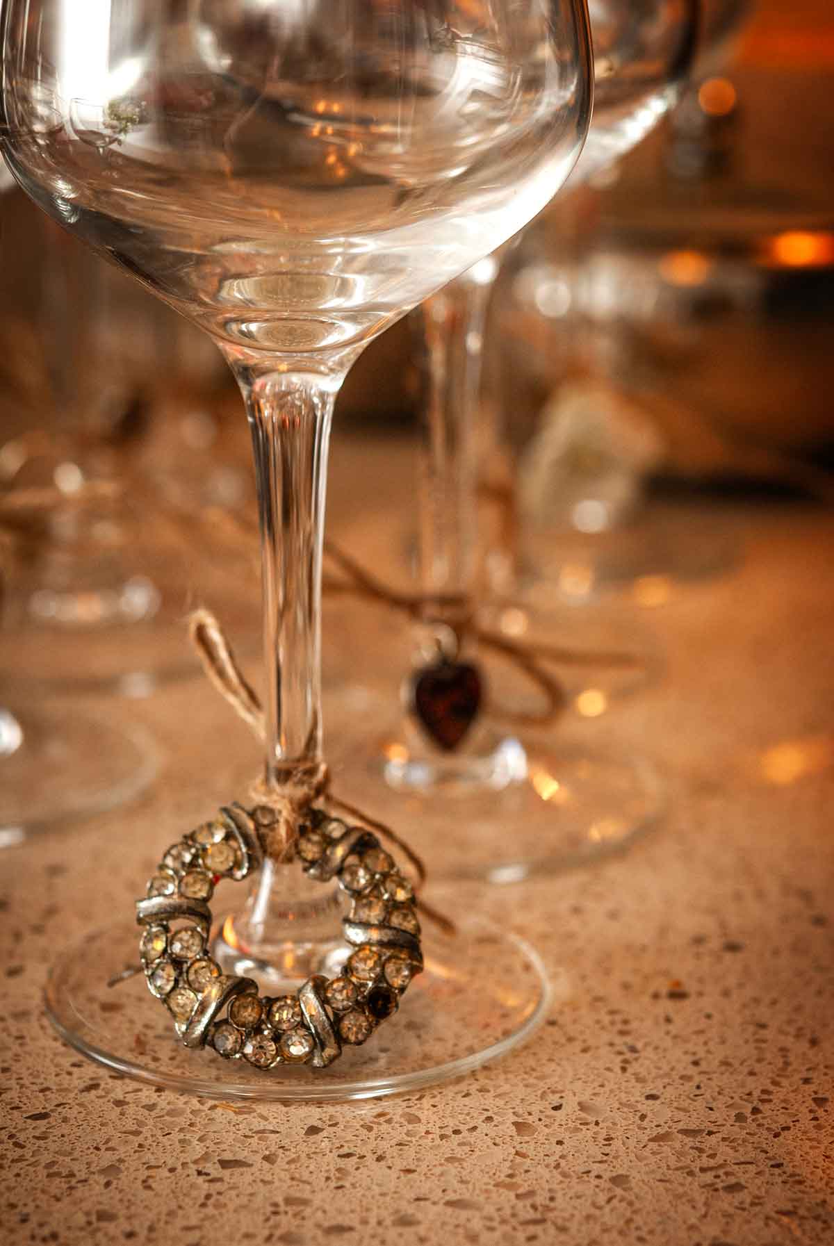 A piece of jewelry tied to a glass.
